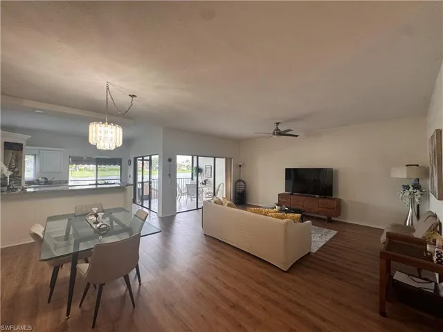 Open concept living area featuring wood flooring and a ceiling fan