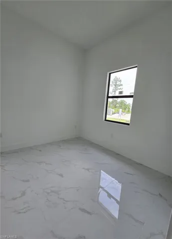 Empty room featuring light marble finish floors