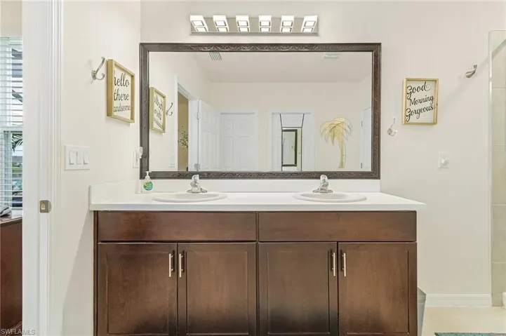 Ensuite featuring dual vanity and tile flooring