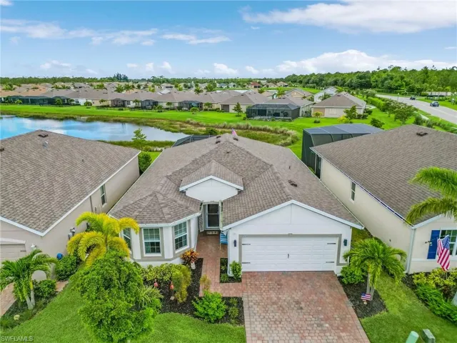 View of front of property featuring a garage and a water view