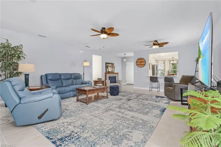 Large Living room featuring tile flooring and ceiling fans