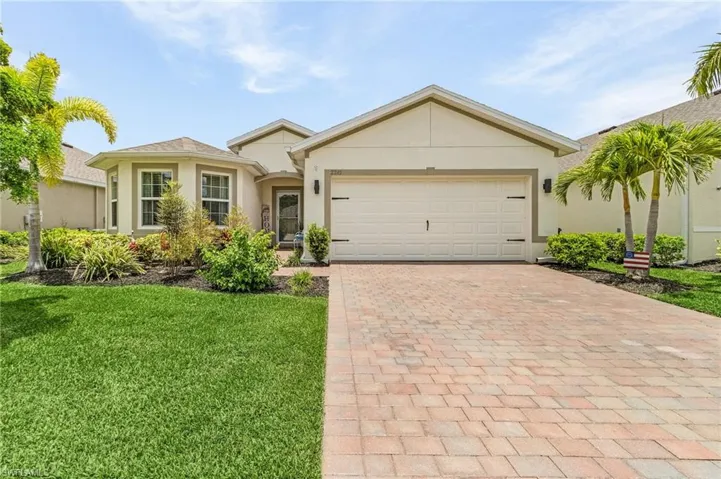 View of front of property featuring a garage and a front yard