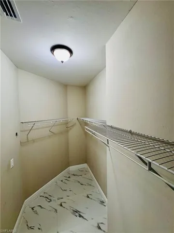 Spacious closet with marble look tiles