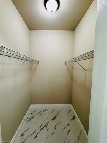 Spacious closet with marble finish floors