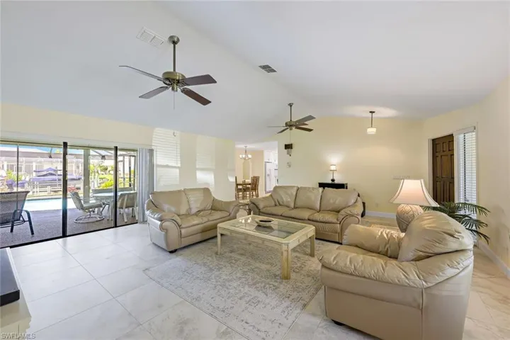 Bright great room has sliders to lanai/pool