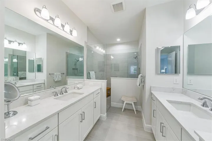 Primary bathroom. Double vanities. Doorless shower.