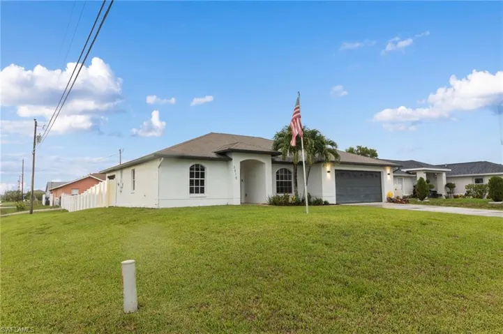 Single story home with a front lawn and a garage