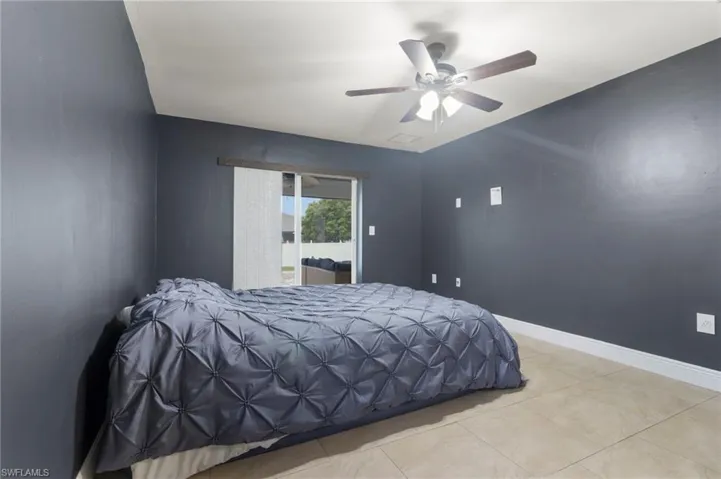 Bedroom featuring ceiling fan and light tile flooring