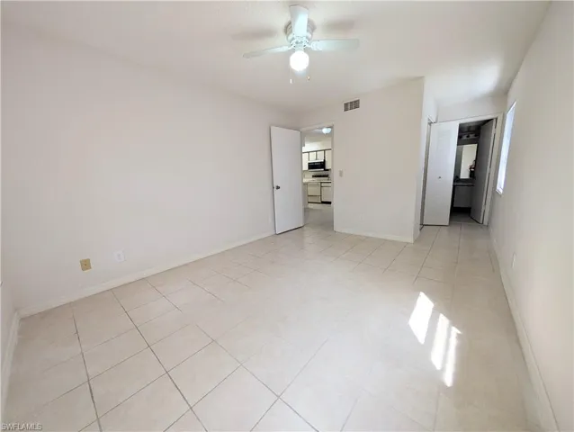 Unfurnished bedroom featuring ceiling fan and light tile patterned floors