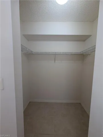 Spacious closet featuring light tile patterned floors