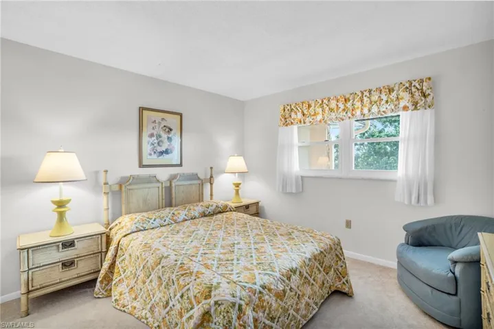 GUEST BEDROOM SUITE WITH POCKET DOOR AND NEWER IMPACT WINDOW..