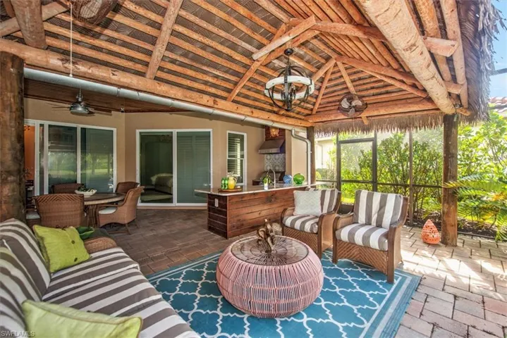 Sunroom / solarium Tiki Bar featuring vaulted ceiling and ceiling fan