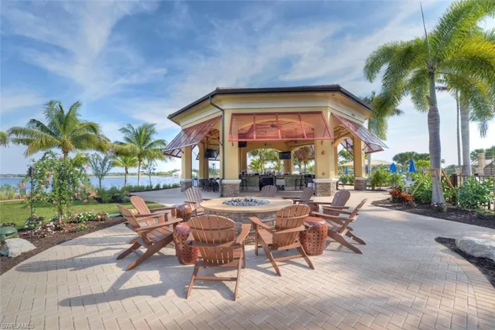 View of patio / terrace with a water view, a gazebo, and a fire pit