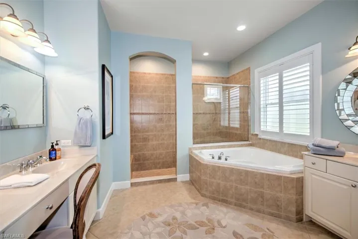 Primary Bathroom with vanity, independent shower and bath, and tile patterned floors