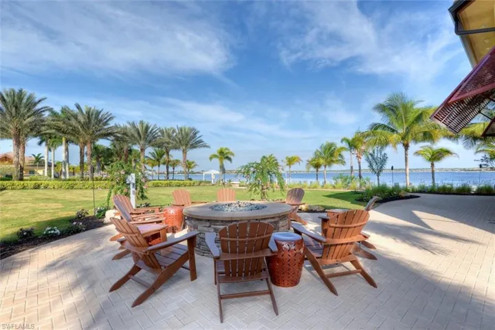 View of patio featuring a water view and an outdoor fire pit