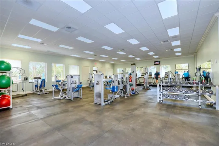 Workout area featuring a paneled ceiling and crown molding