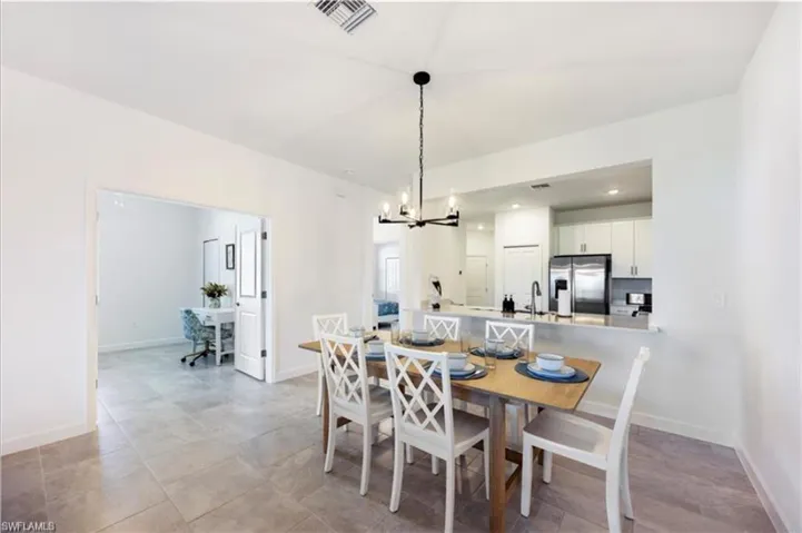 Dining area featuring a chandelier and recessed lighting
