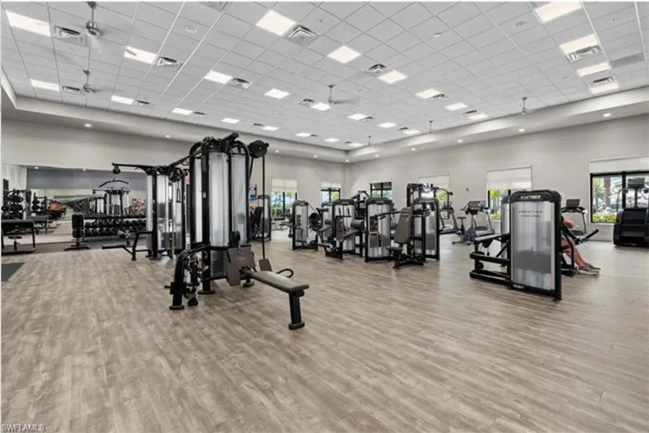 Exercise room with a high ceiling and a drop ceiling