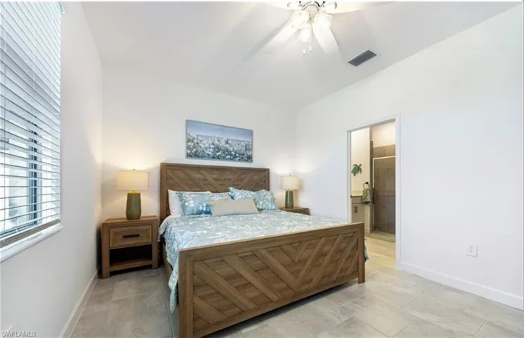 Bedroom with ceiling fan and ensuite bathroom