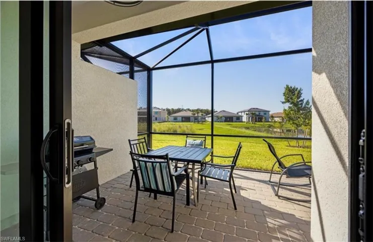 Sunroom featuring a patio area, a residential view, and outdoor dining area
