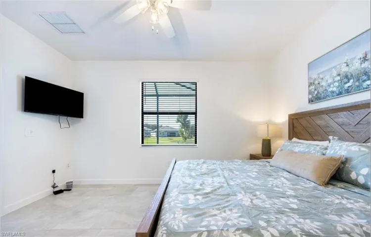 Bedroom featuring a ceiling fan and baseboards