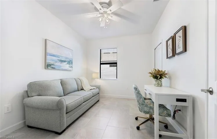 Office space with light tile patterned floors and ceiling fan