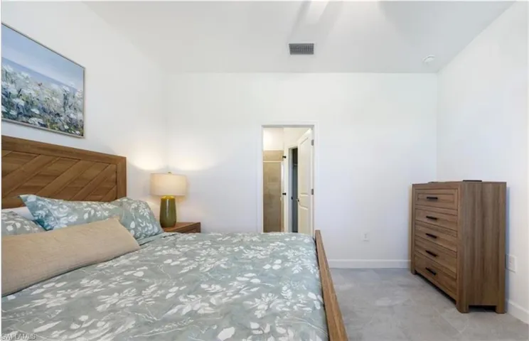 Bedroom featuring a ceiling fan and connected bathroom