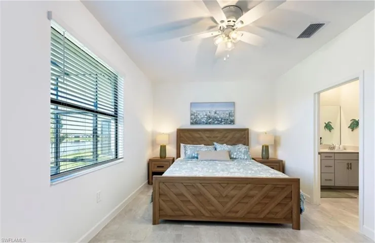 Bedroom featuring connected bathroom and ceiling fan