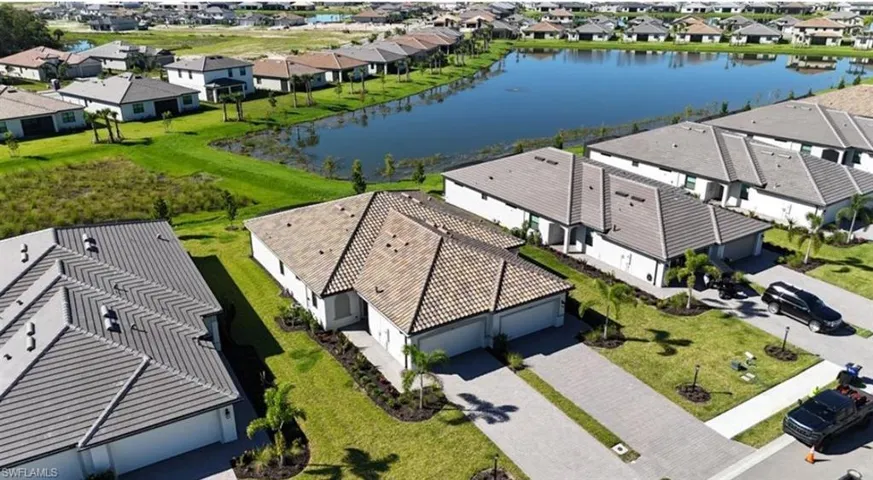 Aerial view of residential area featuring a nearby body of water