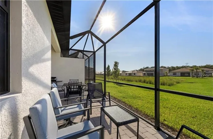 Sunroom with a patio and a residential view