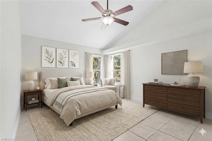 virtual staged Bedroom featuring vaulted ceiling, ceiling fan, and light tile patterned flooring