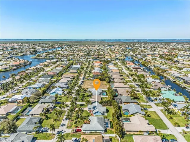 Aerial overview of property's location with nearby suburban area and a large body of water