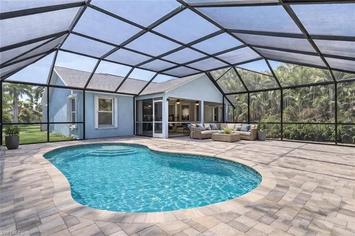 room for pool virtual staged Outdoor pool with a sunroom, glass enclosure, an outdoor hangout area, and a patio