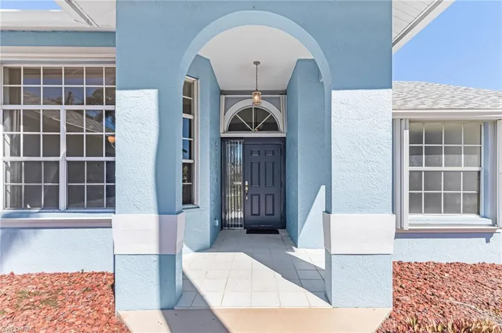 Entrance to property with stucco siding