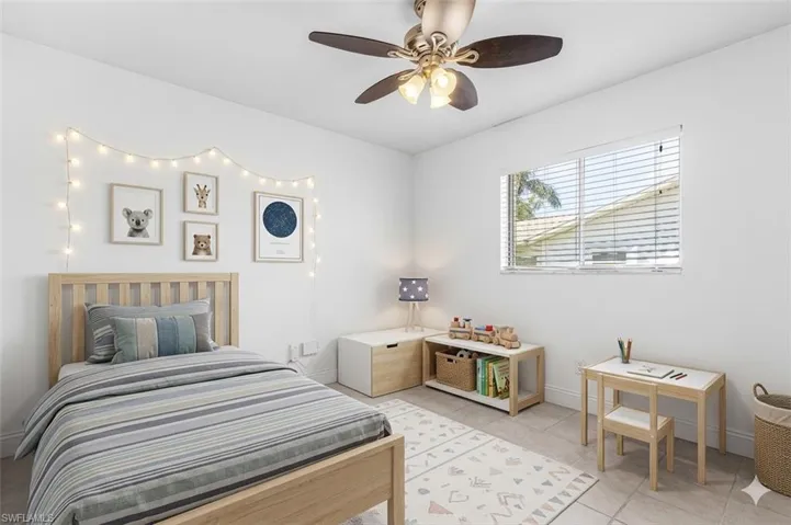 virtual stage Bedroom featuring ceiling fan and light tile patterned floors