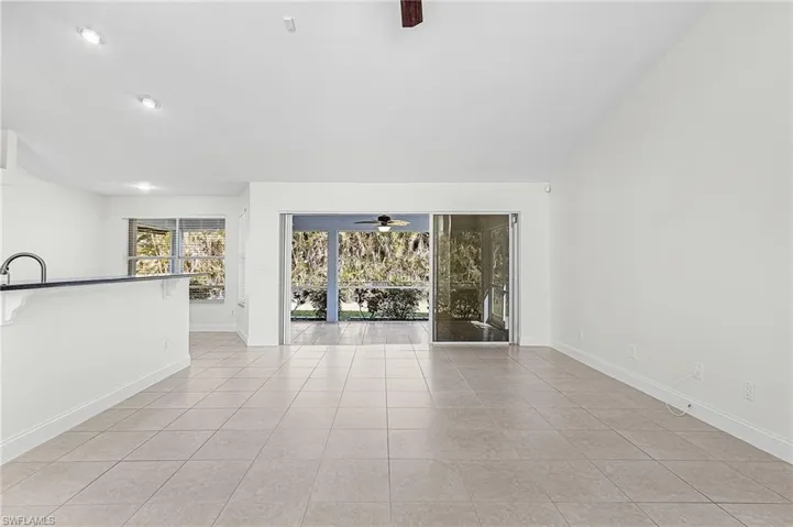 Unfurnished room with a ceiling fan and light tile patterned floors