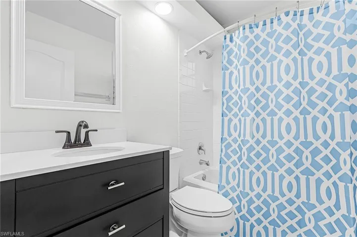 Bathroom with vanity and shower / tub combo