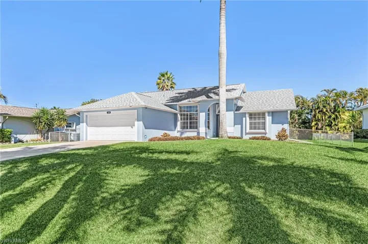 Single story home featuring a garage, stucco siding, driveway, and roof with shingles