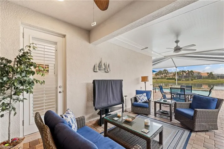 View of patio / terrace with an outdoor hangout area, a water view, and ceiling fan