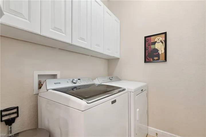 Clothes washing area with cabinets and washing machine and clothes dryer