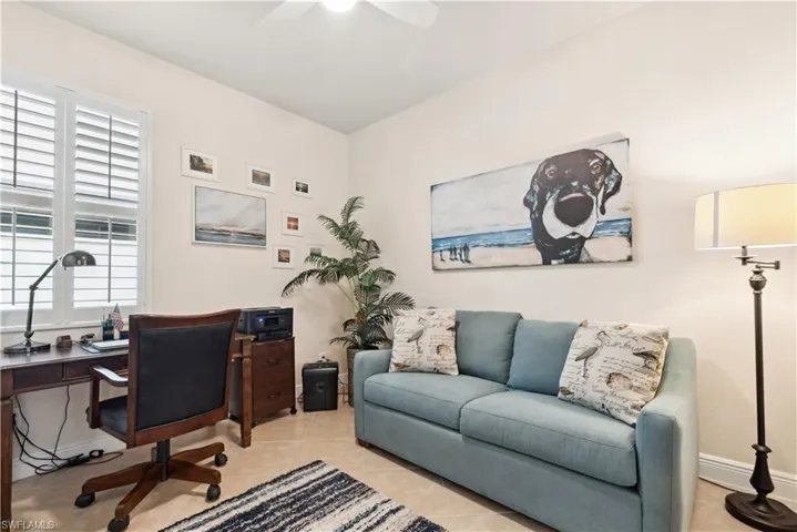 Tiled office space featuring a wealth of natural light and ceiling fan