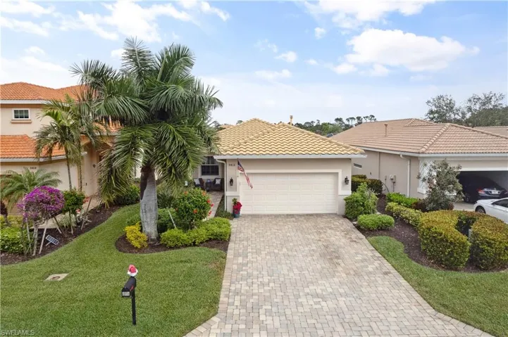 Mediterranean / spanish house featuring a garage and a front lawn