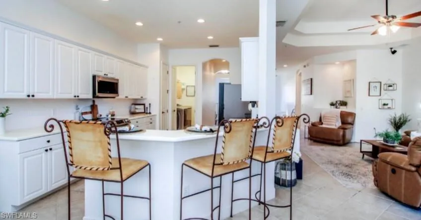 Kitchen with white cabinetry, light countertops, a peninsula, stainless steel appliances, and recessed lighting