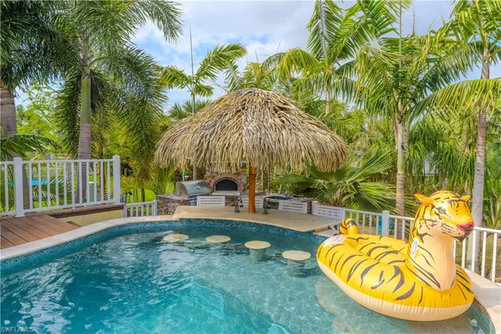 Swimming pool with a wooden deck and a patio area- Virtually Edited Image