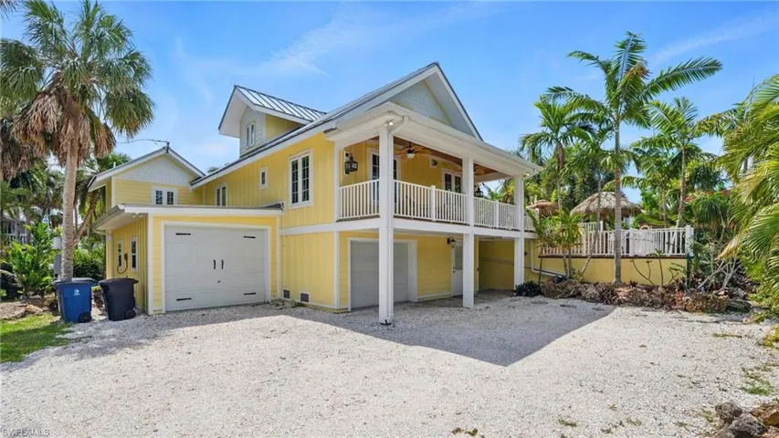 View of front of house featuring a front lawn, driveway, and an attached garage - Virtually Edited Image
