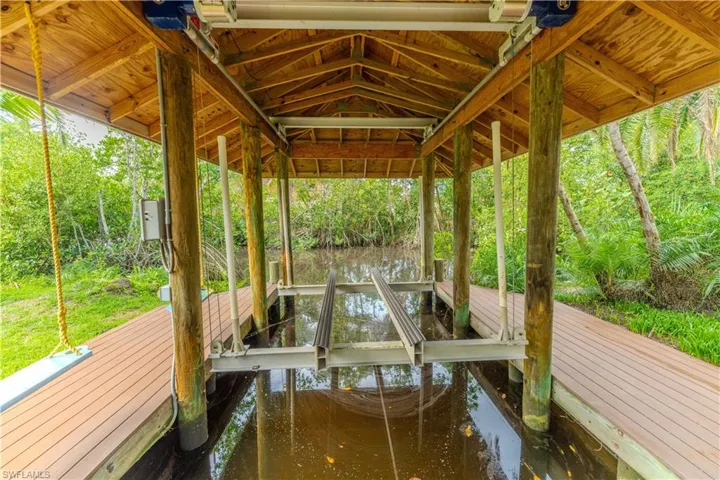 Dock area featuring a water view - Virtually Edited Image