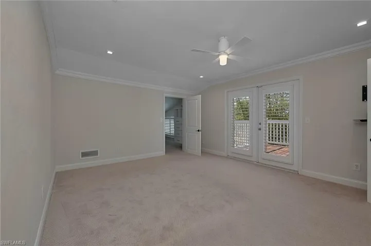 Primary bedroom suite offers access to balcony overlooking the canal.