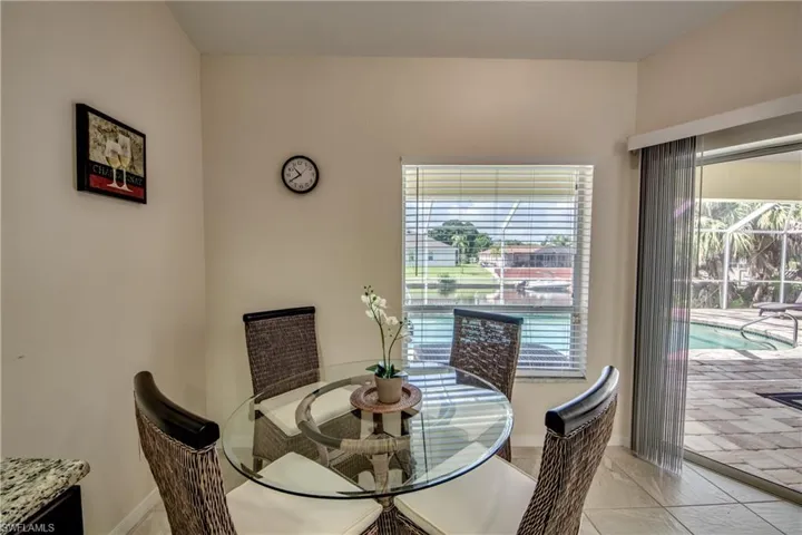Dining area featuring light tile patterned flooring and baseboards