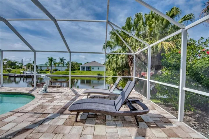 Outdoor pool featuring  a sunroom, and a water view