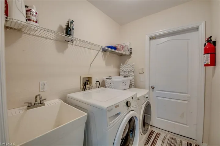 Laundry room with washer and clothes dryer